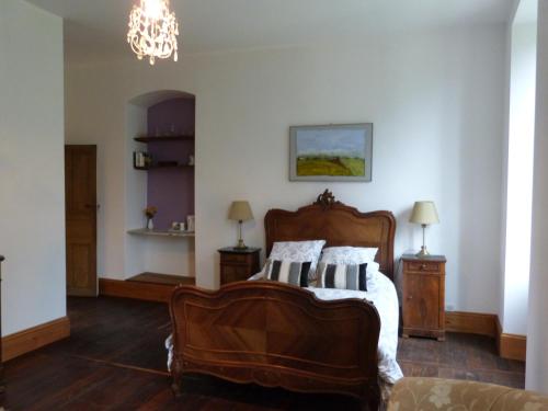 a bedroom with a bed and a chandelier at Cantaranne in Privezac