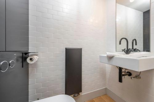 a bathroom with a sink and a toilet at The Good Vibes Parlour - Covent Garden - by Frankie Says in London
