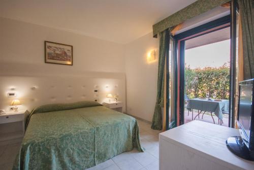a bedroom with a bed and a window with a view at Hotel Residence Villa San Giovanni in Portoferraio