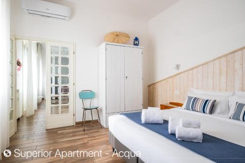 a bedroom with a large white bed with blue accents at Z8 Apartments in Bologna