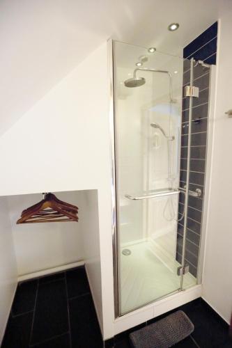 a shower in a bathroom with a glass shower stall at Le Valombré in Saint-Pierre-de-Chartreuse
