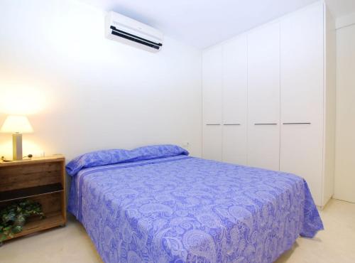 a bedroom with a purple bed and a dresser at Blue fridge apartmen · Blue fridge apartmen · Ideal for couples, near beach and well connected in Vilassar de Mar