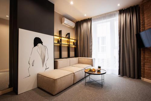 a living room with a couch and a table at Kulikovskiy hotel in Kharkiv