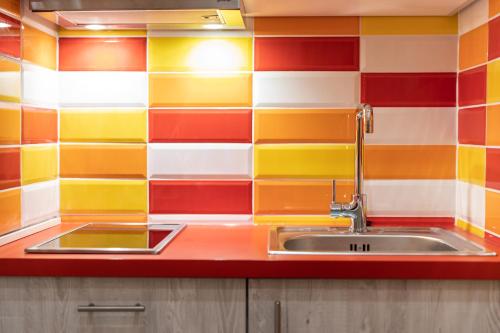 a kitchen with a sink and colorful tiles at Centre point Apartment in Budapest