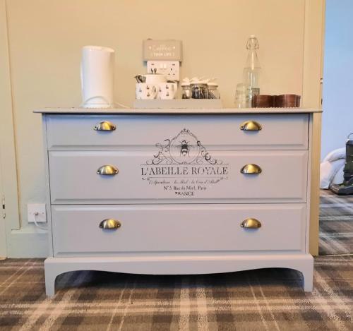 a dresser with a sign on it at Argyle Guest House in Tomintoul