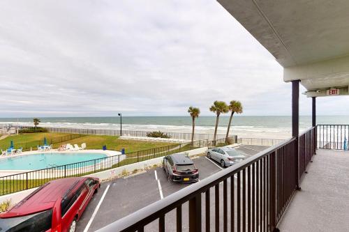 a balcony with cars parked in a parking lot next to the ocean at Atlantico 32 in Daytona Beach