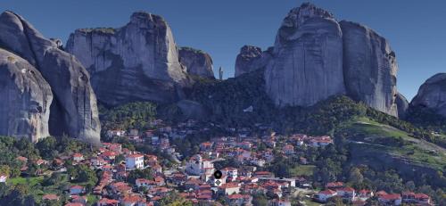 a view of a town in between two mountains at The Stone Forest in Kalabaka