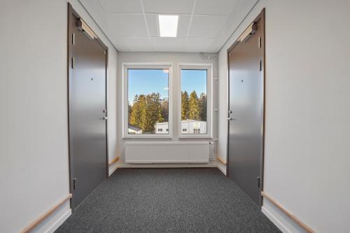 an empty corridor with a window in a building at Uppsala Hotel Apartments in Uppsala