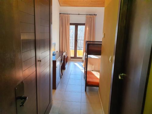 a hallway with a door and a room with a bed at HOTEL MASIA EL MOLINETE in Mora de Rubielos