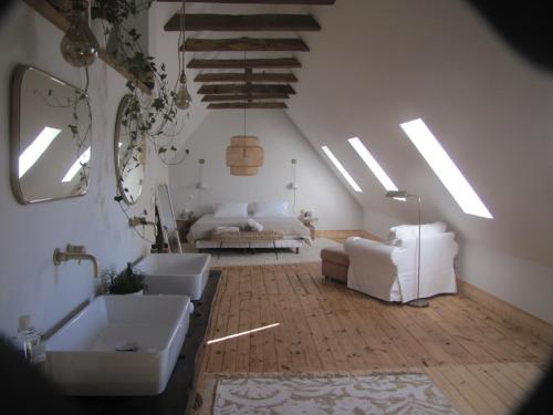 a living room with two sinks and a room with a couch at Esprit Nature Rêve d'étoiles in Graissac