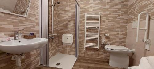 a bathroom with a toilet and a sink and a shower at Locanda della Luna in Ronco Canavese