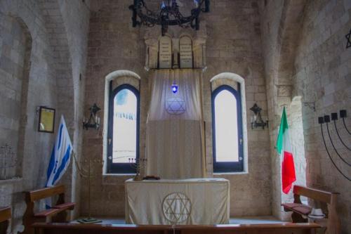 a church with a table in a room with windows at Insula Maris in Trani