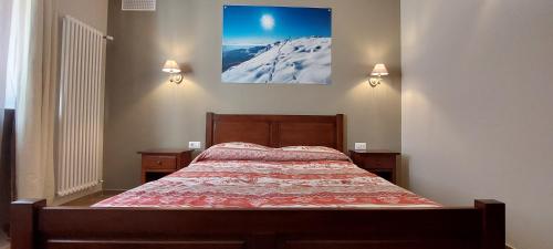 a bedroom with a bed and two night stands at Locanda della Luna in Ronco Canavese