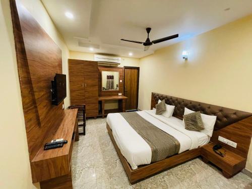 a hotel room with a bed and a television at HOTEL AUGUSTO in Varanasi
