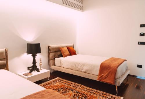 a bedroom with two beds and a couch at Viale dei Lecci - Luxury rooms in Francavilla Fontana
