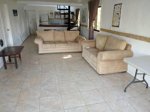 a living room with two couches and a table at El Castillo Monte Campana in Puntarenas
