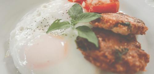 a white plate topped with food with a tomato and sauce at La Bambouseraie in Balgue