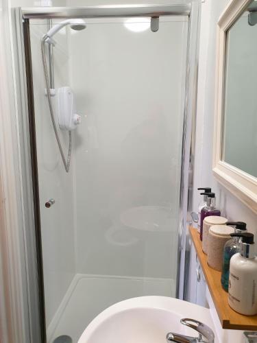 a bathroom with a sink and a shower at The Clarendon Country Pub with rooms in Grassington