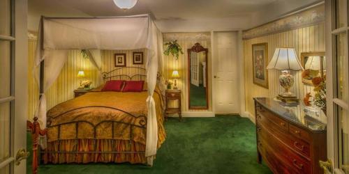 a bedroom with a bed and a dresser in it at Red Coach Inn in Niagara Falls