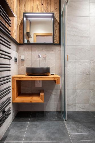 a bathroom with a sink and a mirror at Skyberg Chalet in Mühlbach am Hochkönig
