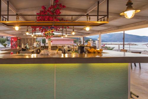 a bar in a restaurant with a pool of water at Sami Beach Hotel in Sami