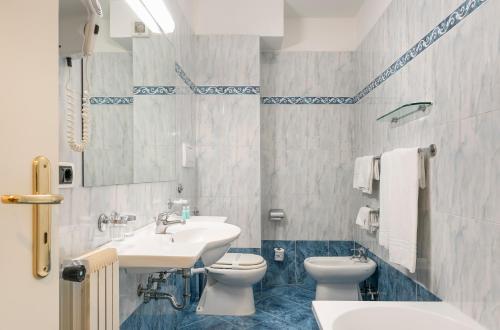 a bathroom with a sink and a toilet at Sant Alphio Garden Hotel & SPA in Giardini Naxos
