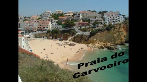 a view of a beach with people in the water at Apartamento na praia do Carvoeiro in Praia do Carvoeiro