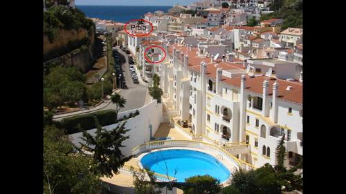 arial view of a city with a building and a pool at Apartamento na praia do Carvoeiro in Praia do Carvoeiro