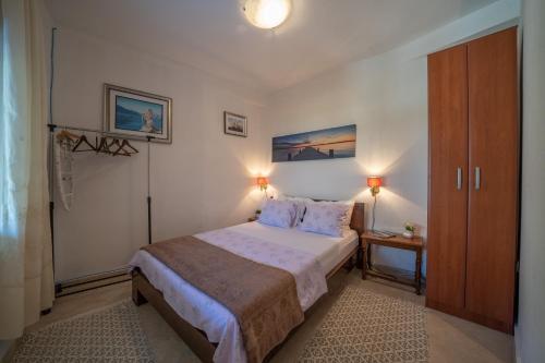 a small bedroom with a bed and a closet at Aneta Apartments in Risan