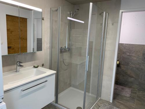 y baño con ducha y lavamanos. en Top Apartment in Zentrumsnähe (Fußläufig), en Schwaz