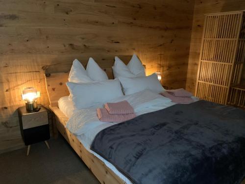 a bedroom with a bed with a wooden wall at Top Apartment in Zentrumsnähe (Fußläufig) in Schwaz