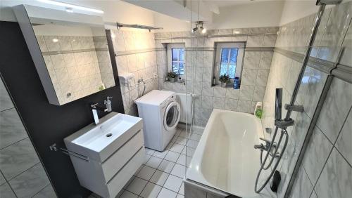 a bathroom with a sink and a washing machine at Parklife Apartments in Winterberg