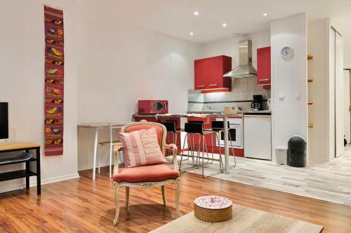 a kitchen with red cabinets and a table and chairs at In the heart of Grenoble #CO in Grenoble