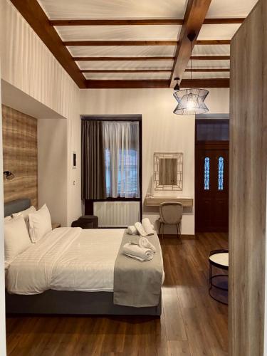 a bedroom with a large bed and a table at 11 Luxury Apartments Metsovo. in Metsovo