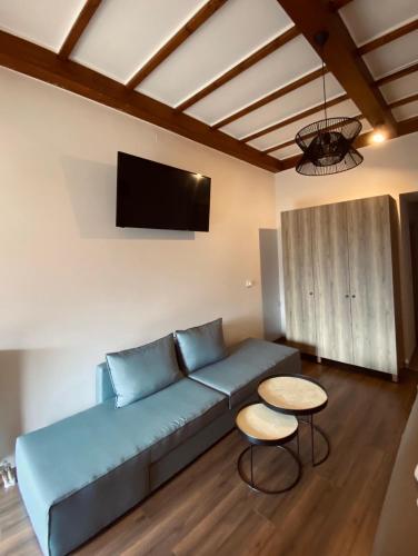 a living room with a blue couch and a table at 11 Luxury Apartments Metsovo. in Metsovo