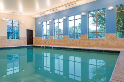 a swimming pool with windows in a house at Hyatt Place Charleston Airport / Convention Center in Charleston