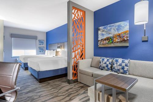 a hotel room with a bed and a couch at Best Western Plus Castlerock Inn & Suites in Bentonville