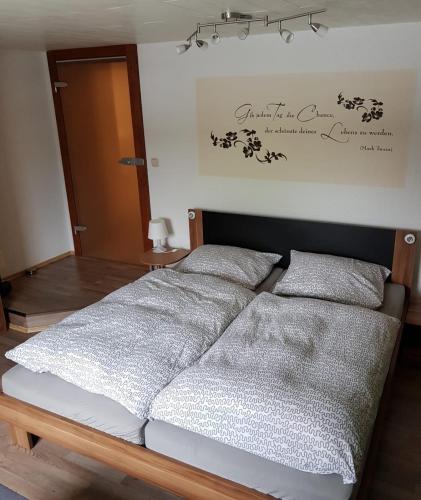 a bed with two pillows on it in a room at Ferienwohnung Hähnert in Schwarzenberg