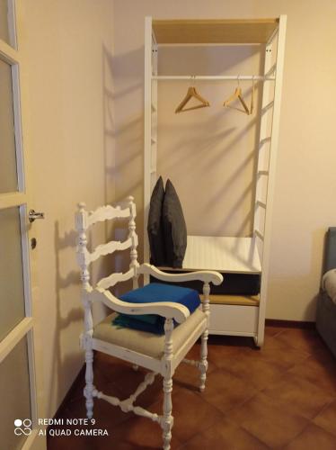 a white chair sitting in front of a bunk bed at Mulino di Limido in Zerbolò