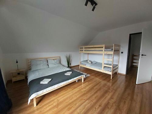 a bedroom with a bed and a book shelf at Sarnie wzgórze Sucha Beskidzka sauna jacuzzi in Kuków