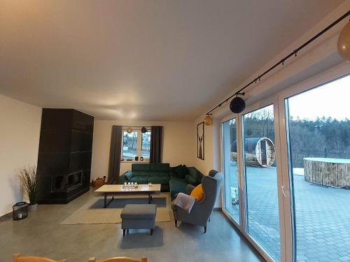 a living room with a couch and a table at Sarnie wzgórze Sucha Beskidzka sauna jacuzzi in Kuków