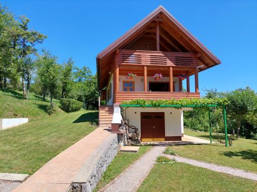 a small house on a hill with a yard at Holiday home Tihovo in Delnice
