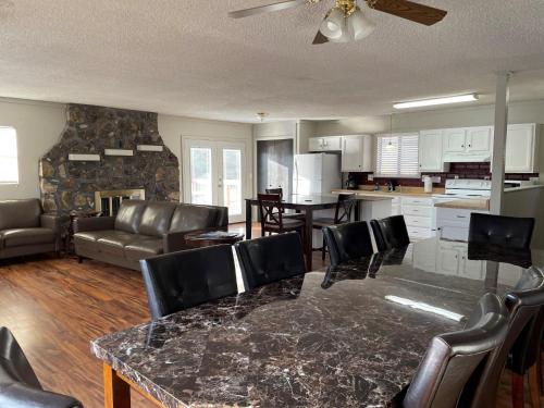 a kitchen and living room with a table and chairs at Sunset Beach Resort in Osage Beach