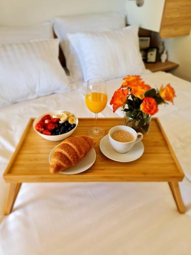 a tray of breakfast foods and a glass of orange juice at LUXURY MOBILE HOMES IVACI in Rovinj