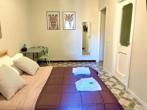 a bedroom with a large bed with towels on it at amurimè in Porto Empedocle