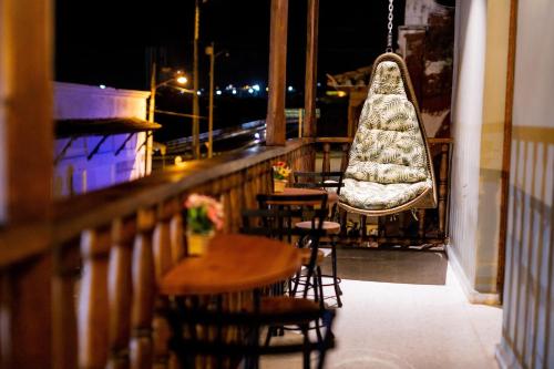 a balcony with tables and chairs at night at Scalea Di Mare Hotel in Cartagena de Indias