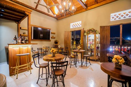 a restaurant with tables and chairs in a room at Scalea Di Mare Hotel in Cartagena de Indias