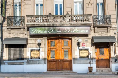 a building with a sign for a store at Hôtel de Charme Le Provence in Salon-de-Provence