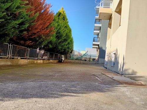 an empty parking lot next to a building at Semi-Basement 250m from Sea, Nea Chili in Alexandroupoli