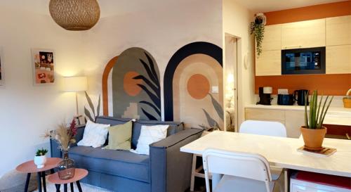 un salon avec un canapé bleu et une table dans l'établissement Le 102, Maison avec Terrasse et parking Gare de ROUEN, à Rouen